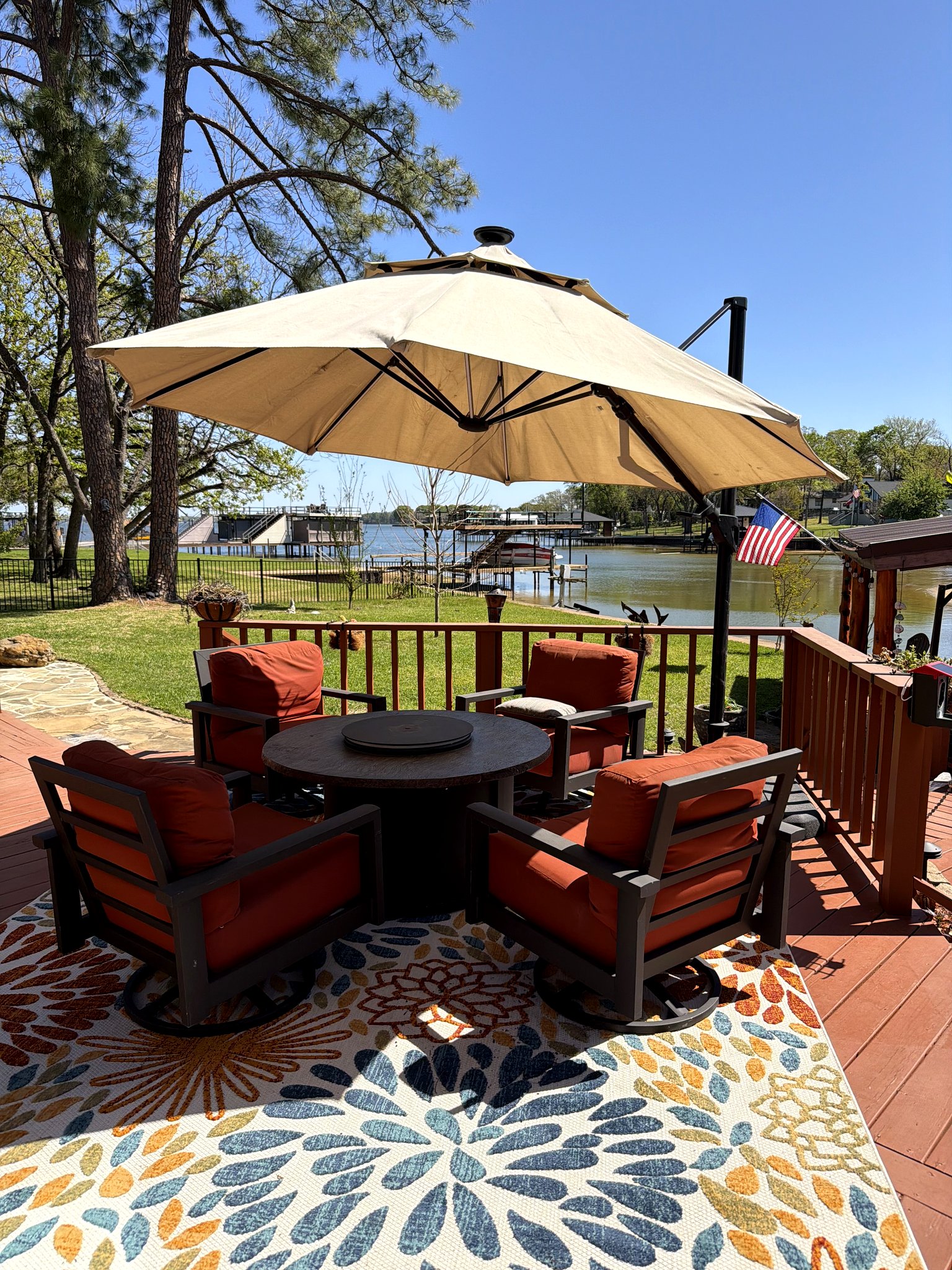 Lakefront deck at Bayside on Cedar Creek with umbrella, outdoor seating, and Cedar Creek Lake views in Star Harbor, Texas