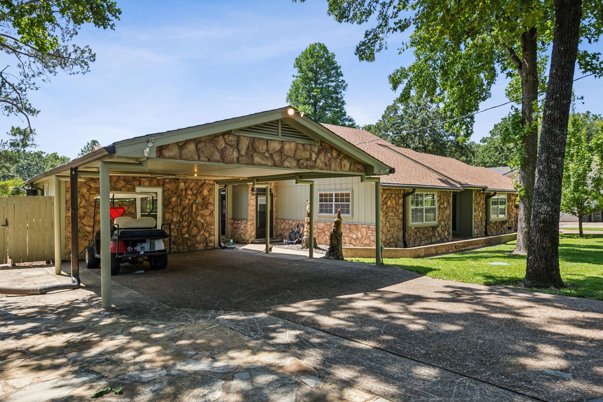 Bayside on Cedar Creek exterior with stone facade and covered parking